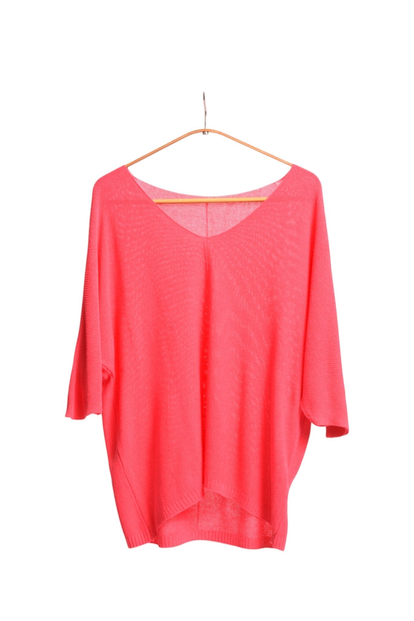 All Above Boutique coral pink V-neck relaxed fit knit sweater with dropped shoulders and a textured bob de orez finish.