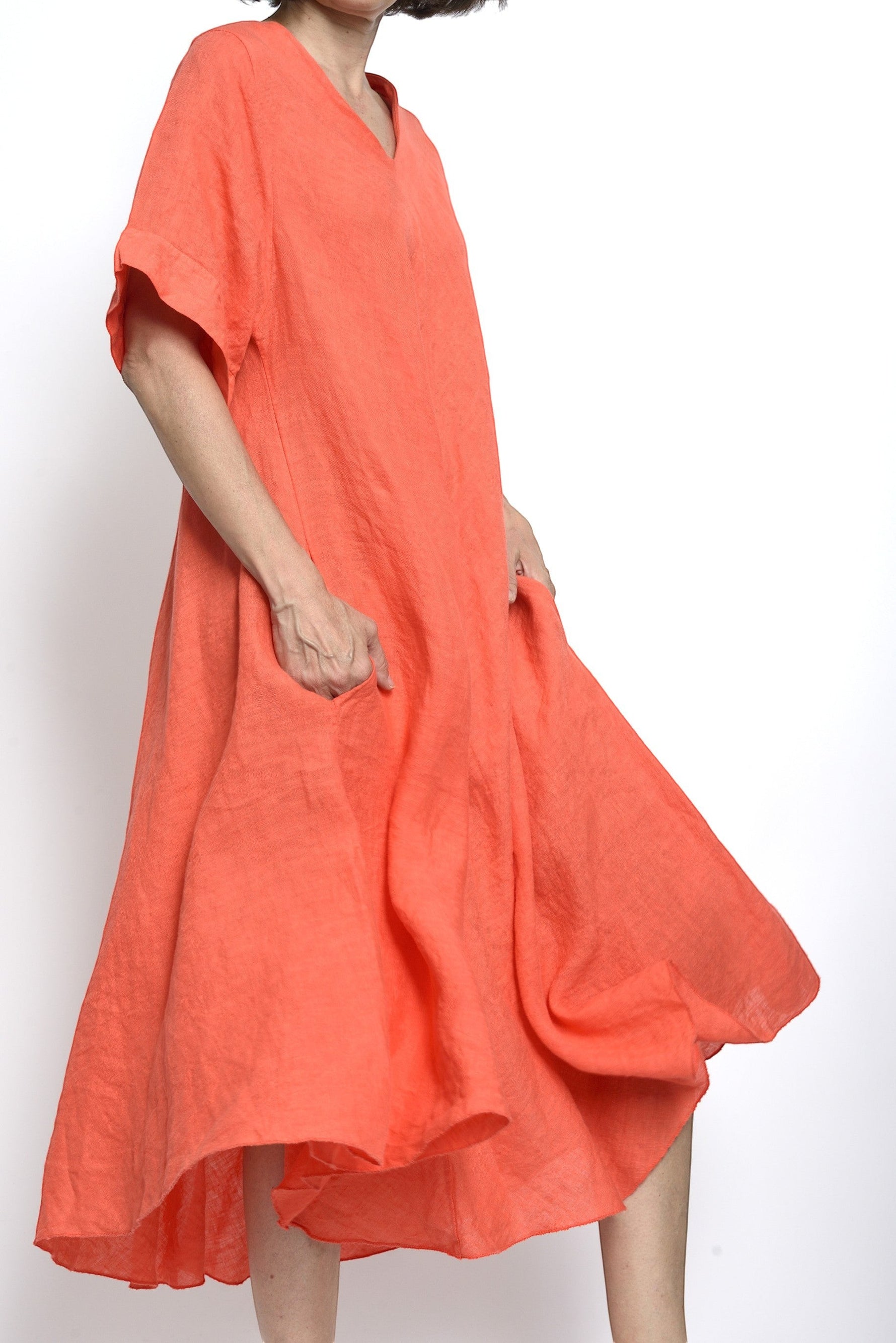 All Above Boutique coral orange 100% linen V-neck midi dress with short sleeves and side pockets.