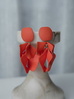 All Above Boutique coral matte metal petal drop earrings with geometric base. Elegant, dynamic, and lightweight statement earrings.