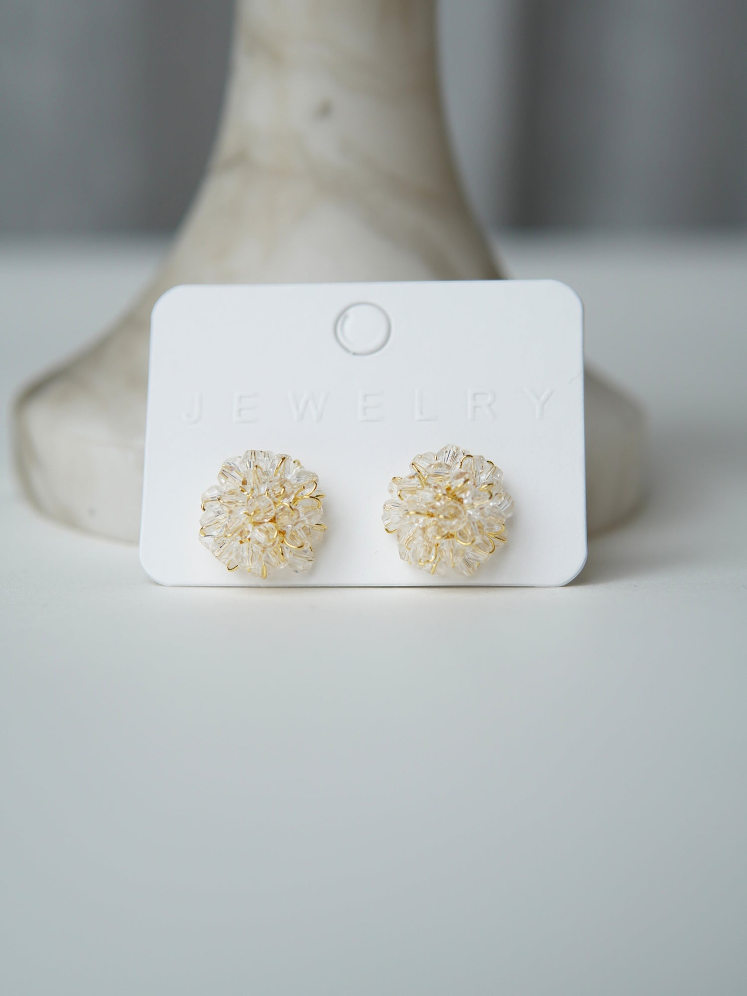 All Above Boutique delicate gold wire earrings with clear crystal flower design. Elegant and versatile.