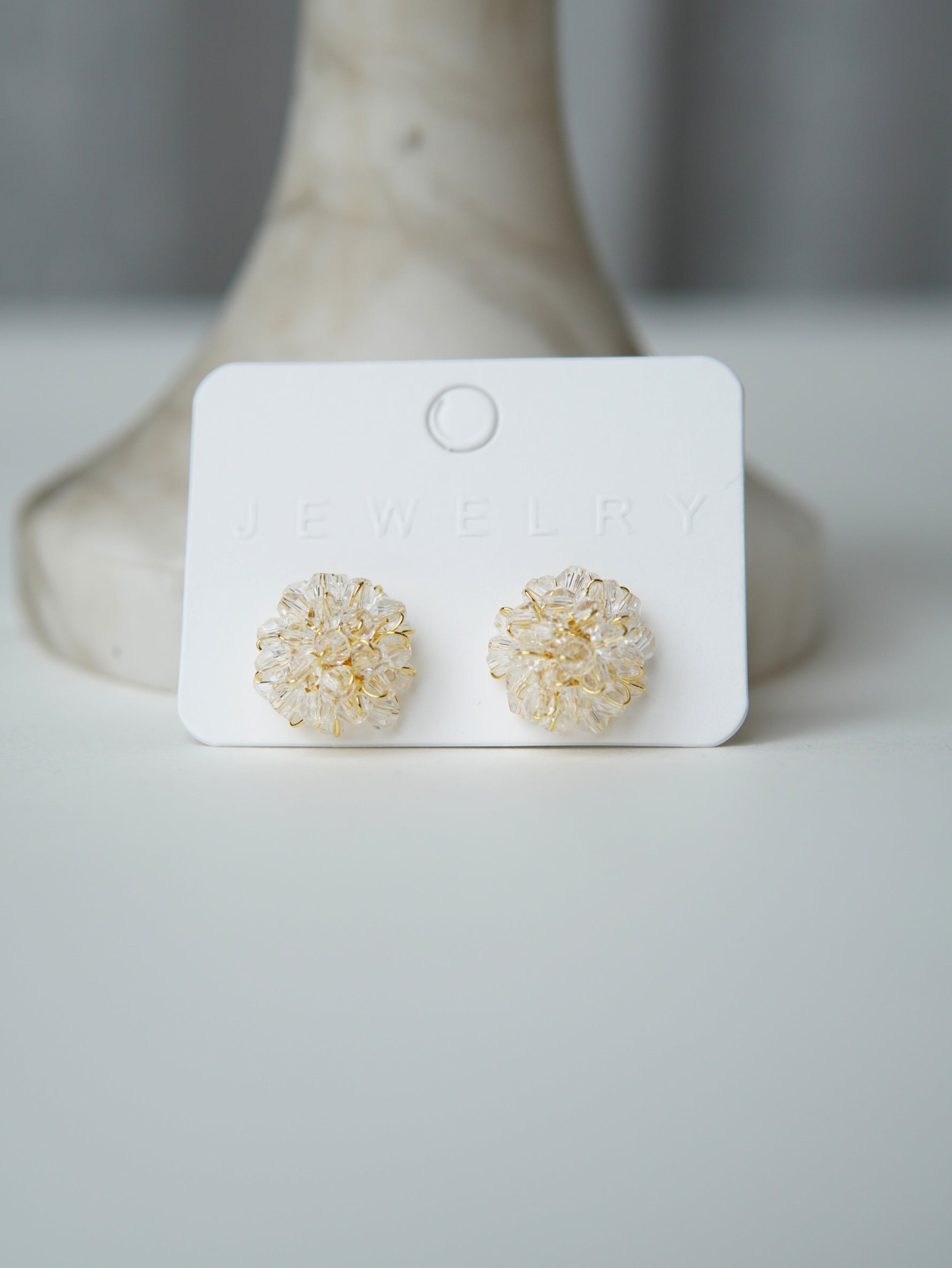 All Above Boutique delicate gold wire earrings with clear crystal flower design. Elegant and versatile.