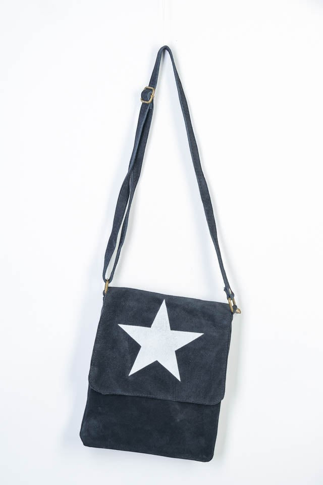 All Above Boutique dark grey suede crossbody bag with a large white star detail and adjustable strap.