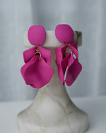 All Above Boutique matte fuchsia petal drop earrings with geometric base. Elegant, dynamic, and lightweight statement jewelry.
