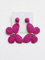 All Above Boutique statement boho butterfly earrings in vibrant fuchsia raffia with gold accents.