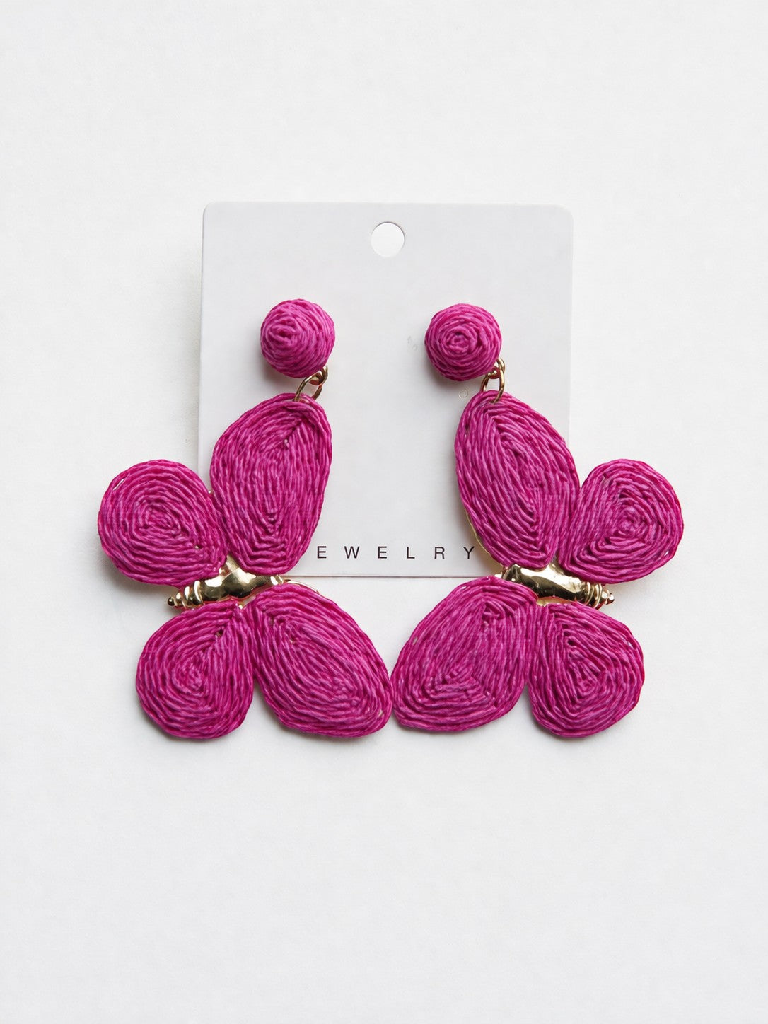 All Above Boutique statement boho butterfly earrings in vibrant fuchsia raffia with gold accents.