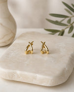 All Above Boutique gold organic asymmetrical modern earrings with a polished finish.