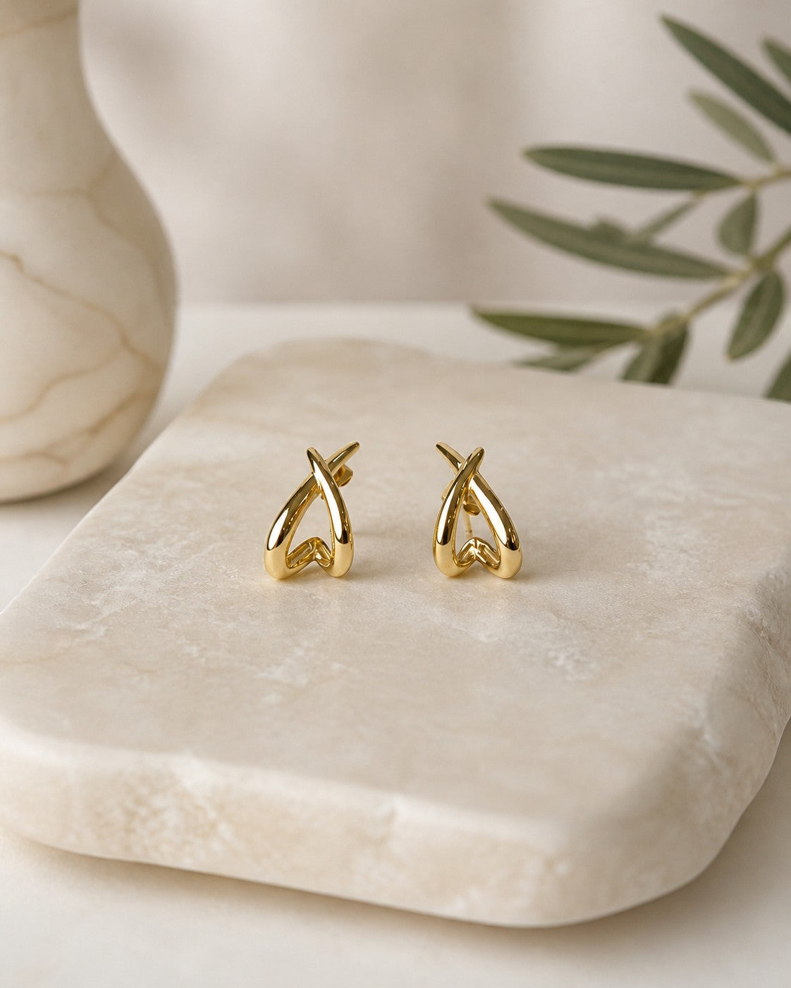 All Above Boutique gold organic asymmetrical modern earrings with a polished finish.