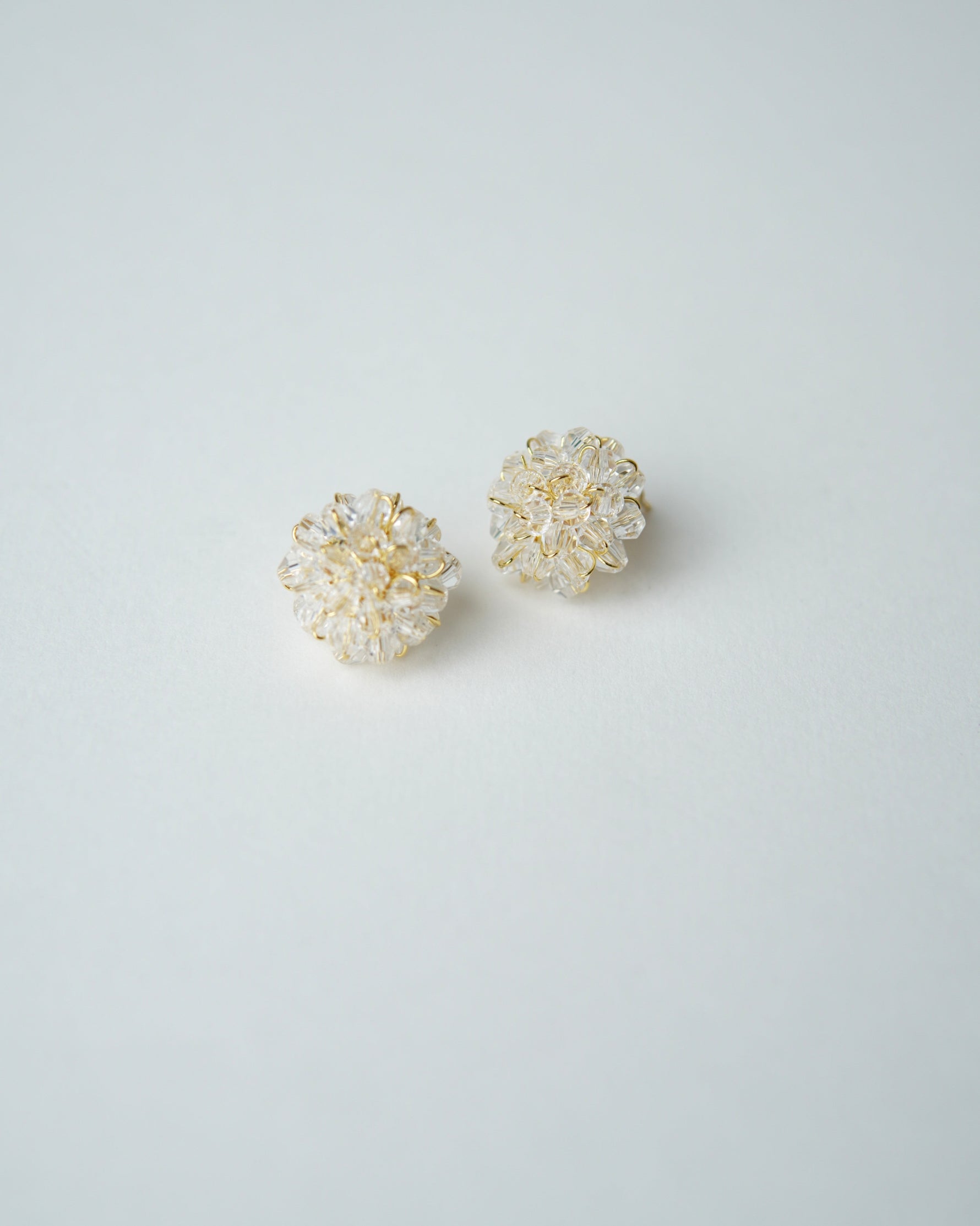 All Above Boutique delicate gold wire earrings with clear crystal flower design, perfect for special occasions.