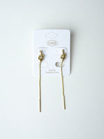 All Above Boutique gold knot drop earrings with long chain and bar end, minimalist stainless steel jewelry.