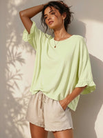 All Above Boutique light green cotton 3/4 sleeve relaxed fit t-shirt with ruffled cuffs.