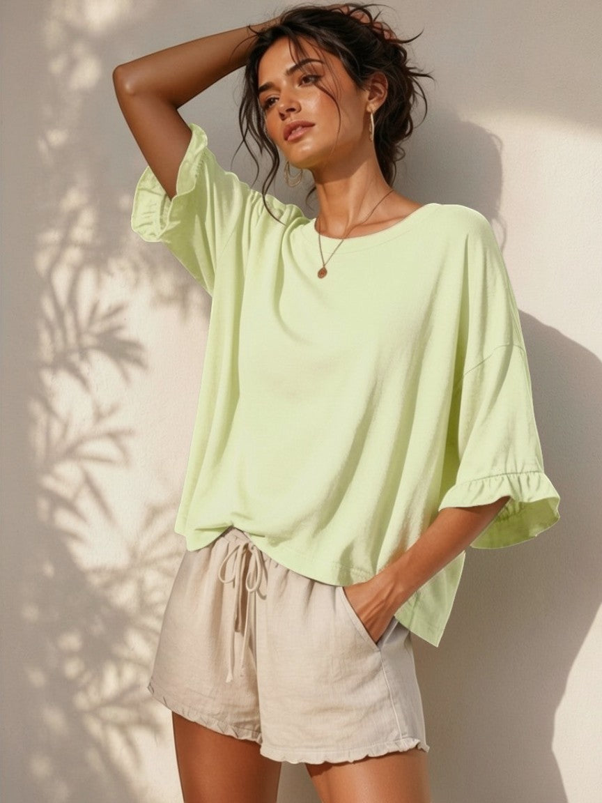 All Above Boutique light green cotton 3/4 sleeve relaxed fit t-shirt with ruffled cuffs.