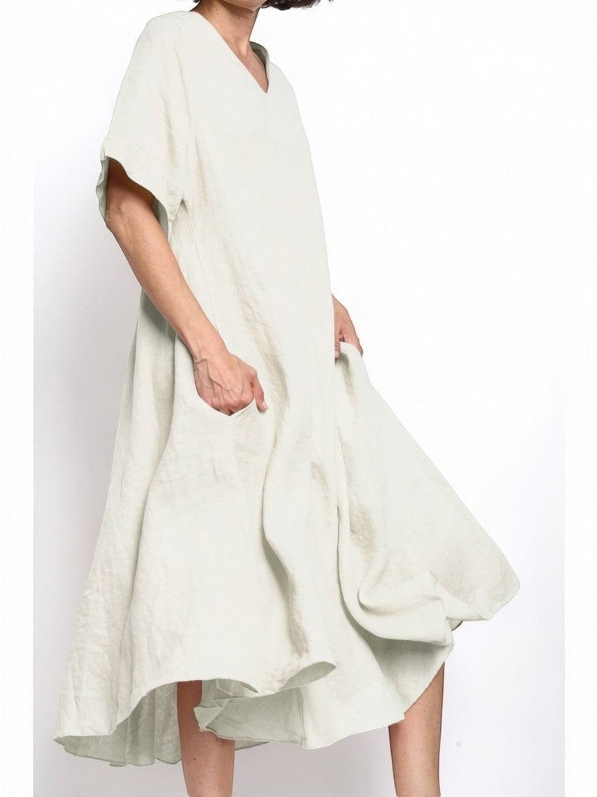 All Above Boutique light green 100% linen V-neck flared midi dress with short sleeves and side pockets.