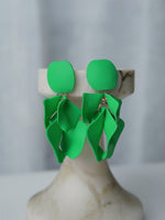 All Above Boutique green metal matte petal drop earrings with geometric rhomboid base. Elegant, dynamic, and lightweight statement jewelry.