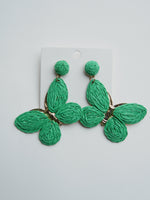 All Above Boutique statement boho green raffia butterfly earrings with gold accents.