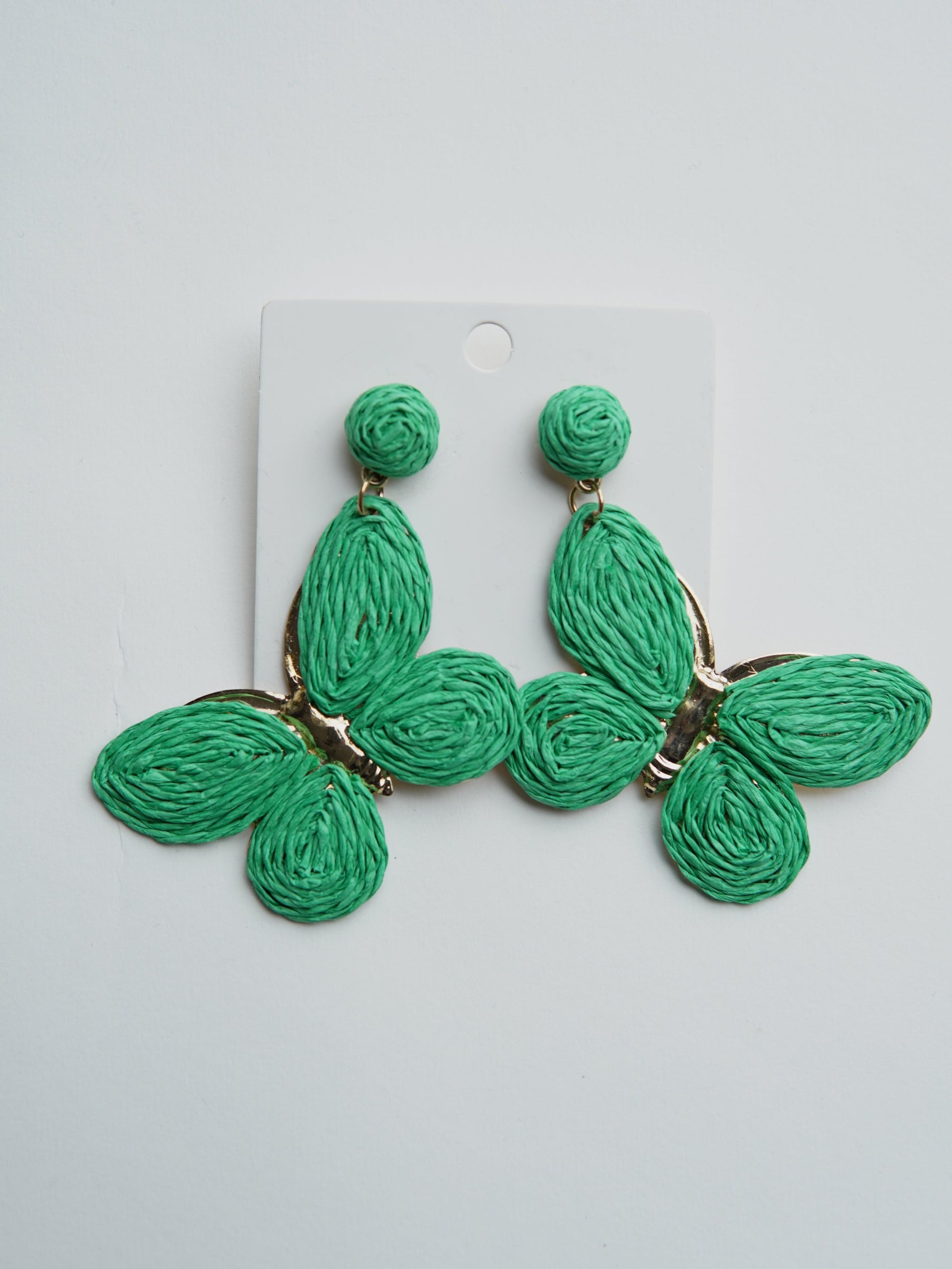 All Above Boutique statement boho green raffia butterfly earrings with gold accents.