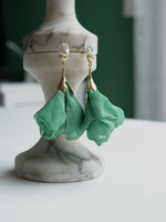 All Above Boutique green satin flower and pearl drop earrings. Gold-tone stainless steel.