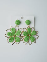All Above Boutique green straw double flower earrings with gold frame, boho chic style.