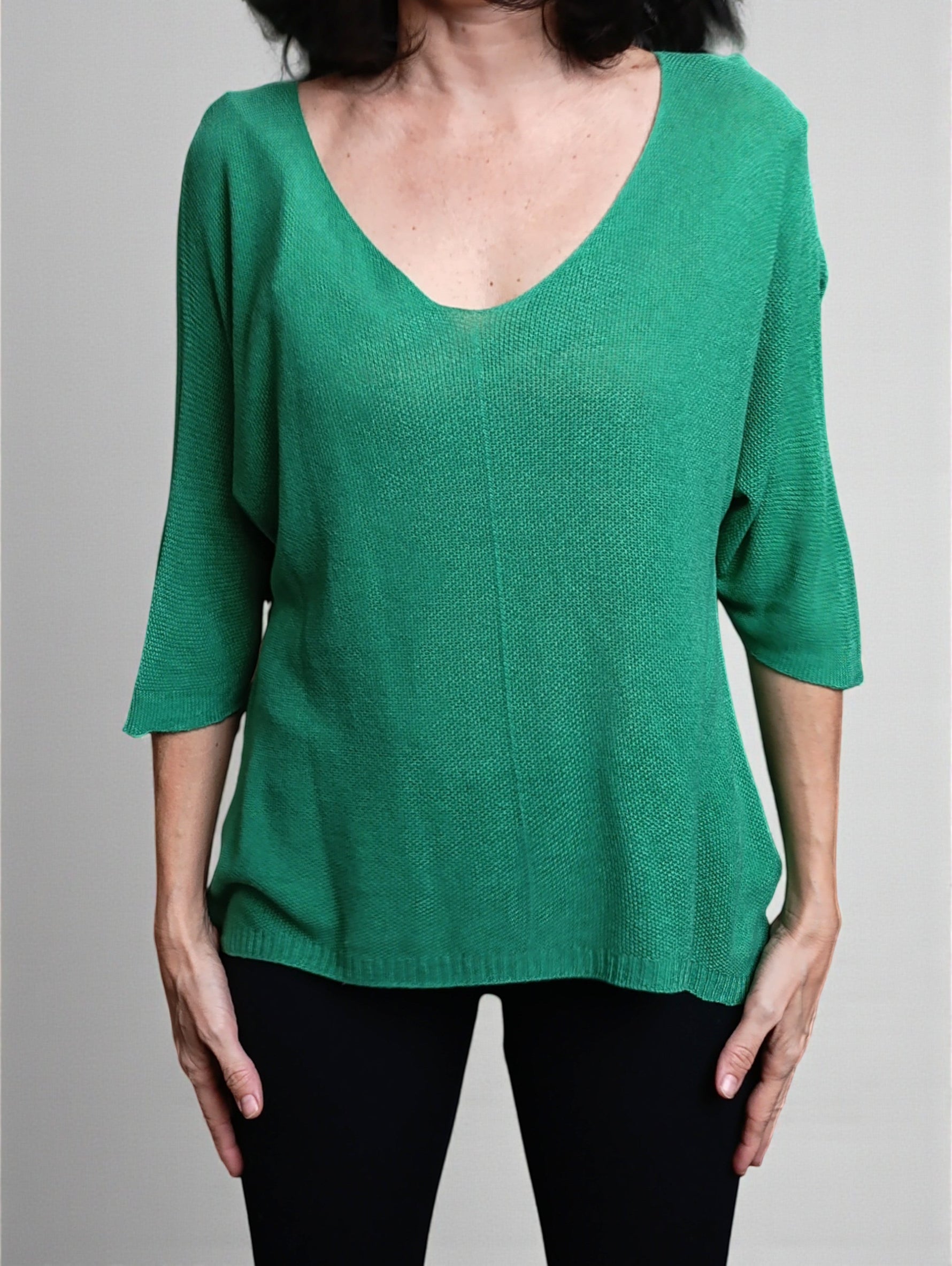 All Above Boutique green V-neck relaxed fit knit sweater with dropped shoulders and 3/4 sleeves.