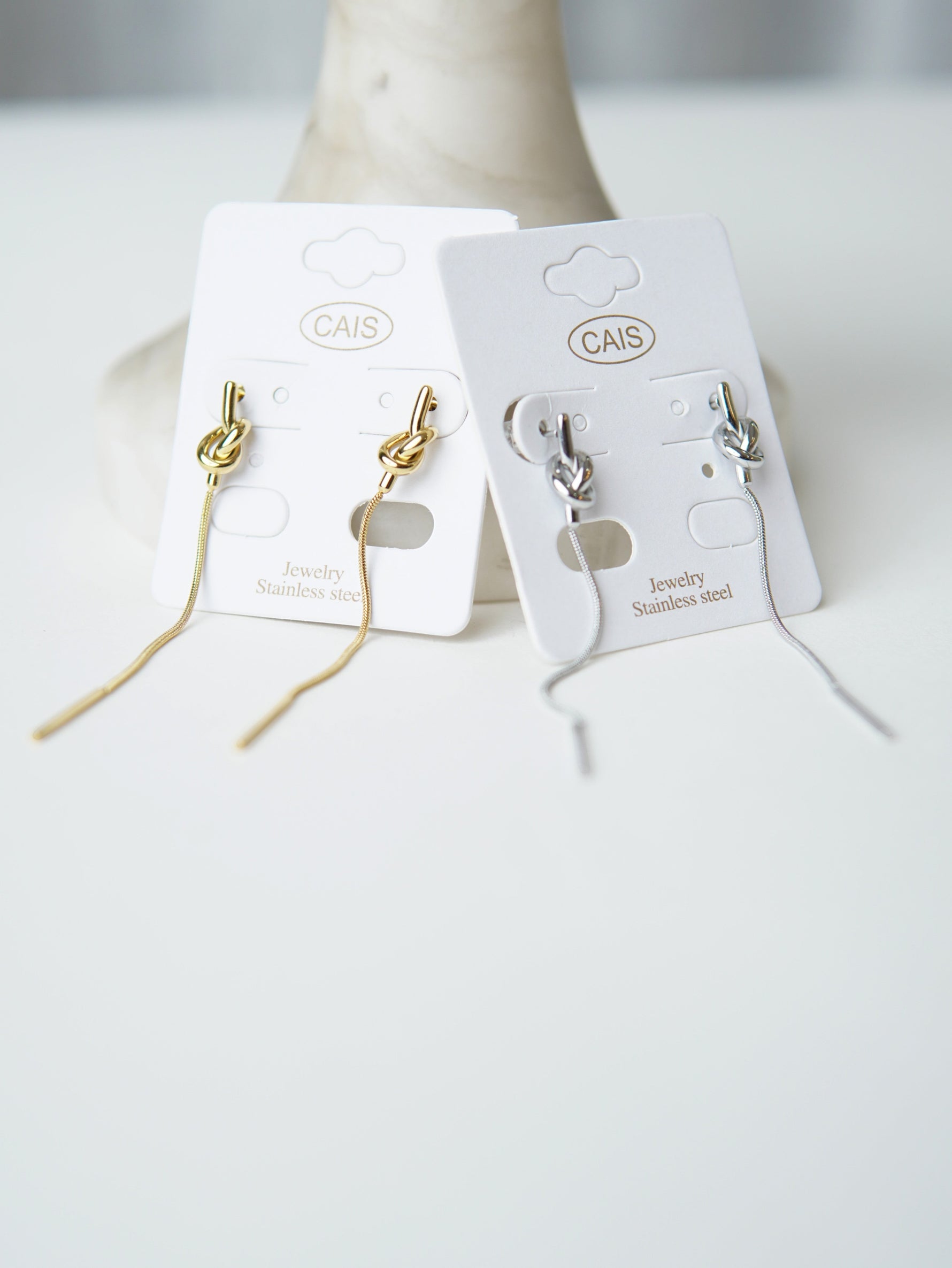 All Above Boutique gold and silver knot drop earrings with snake chain, minimalist design.