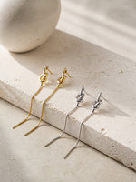 All Above Boutique gold and silver knot drop earrings with snake chain, minimalist design.