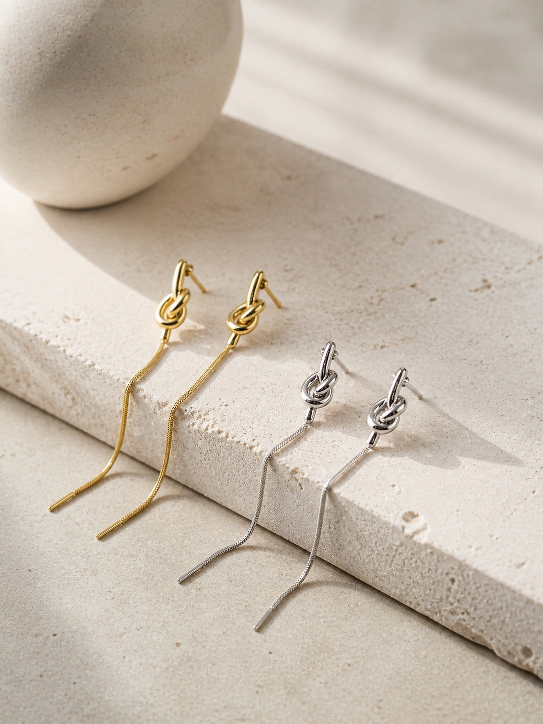 All Above Boutique gold and silver knot drop earrings with snake chain, minimalist design.