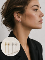 All Above Boutique minimalist long drop earrings with knot detail in silver and gold.