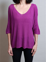 All Above Boutique magenta V-neck relaxed fit knit sweater with dropped shoulders and 3/4 sleeves.