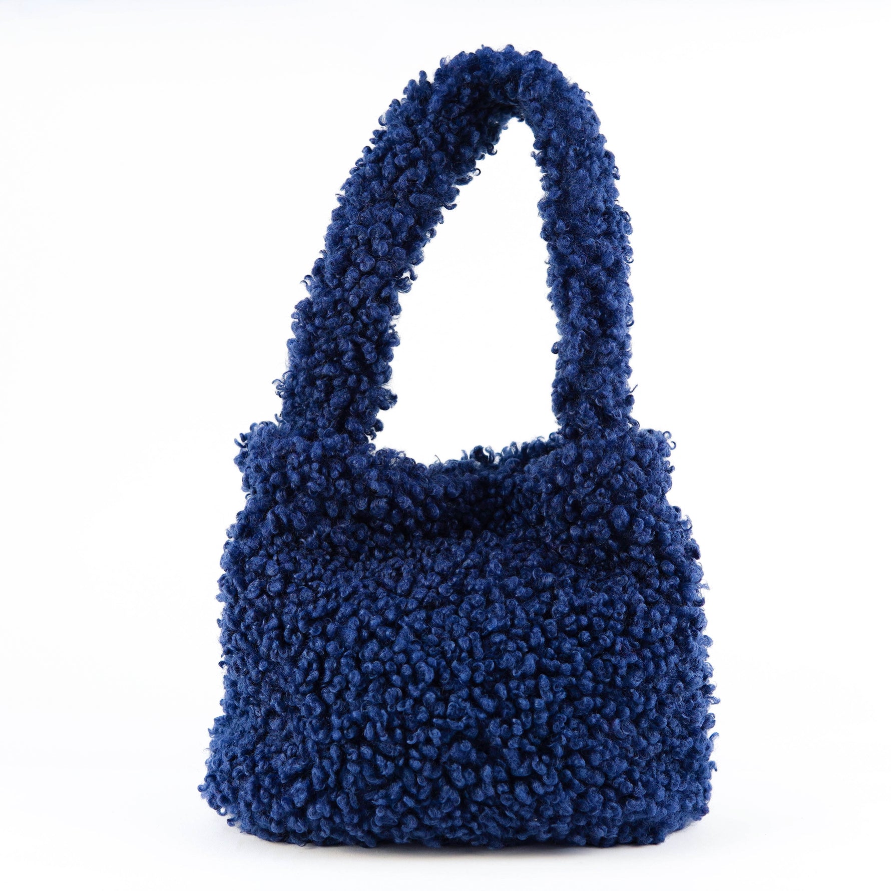 All Above Boutique navy blue teddy bear fleece handbag with double handles and magnetic snap closure.