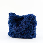All Above Boutique navy blue teddy fabric tote bag with double handles and magnetic snap closure.