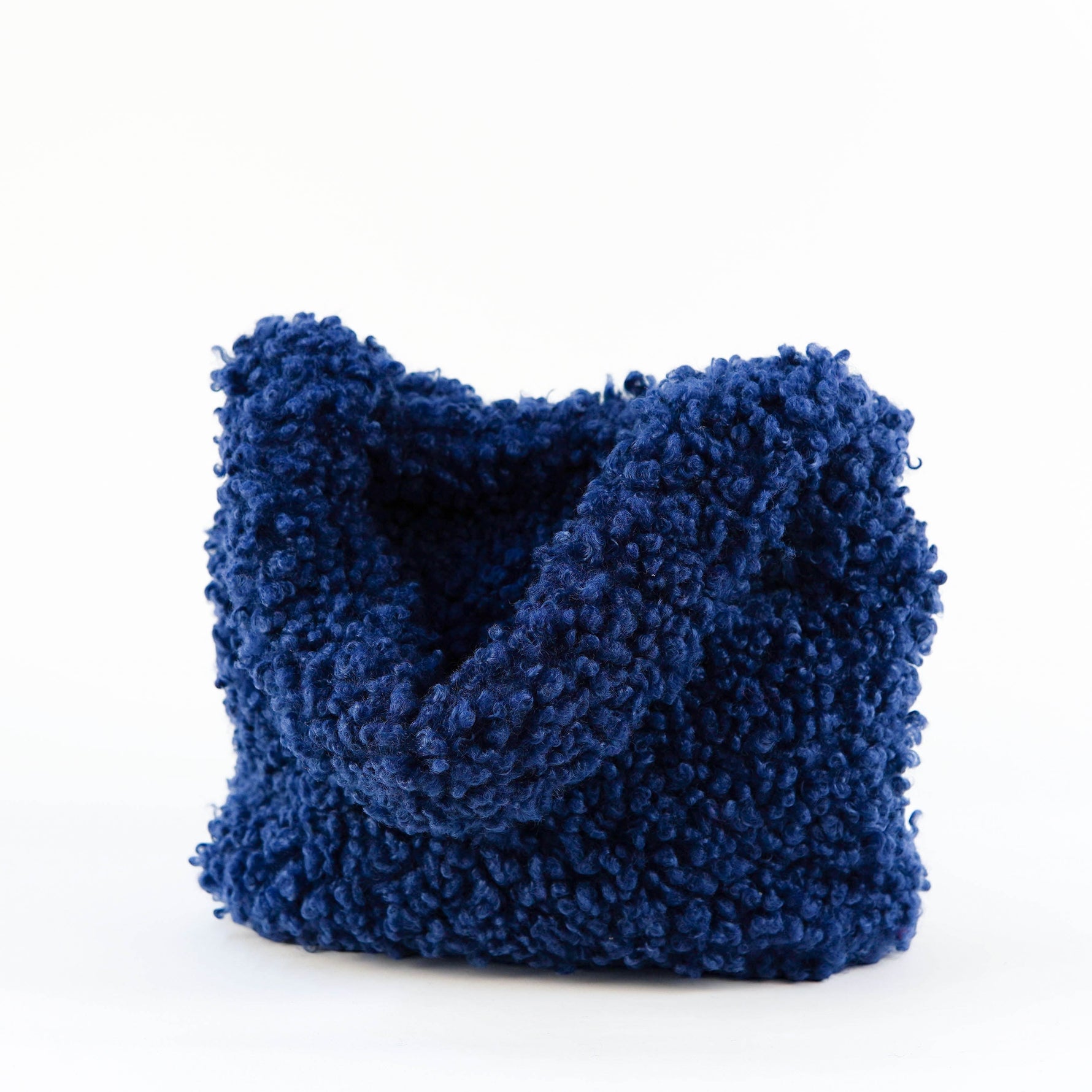 All Above Boutique navy blue teddy fabric tote bag with double handles and magnetic snap closure.