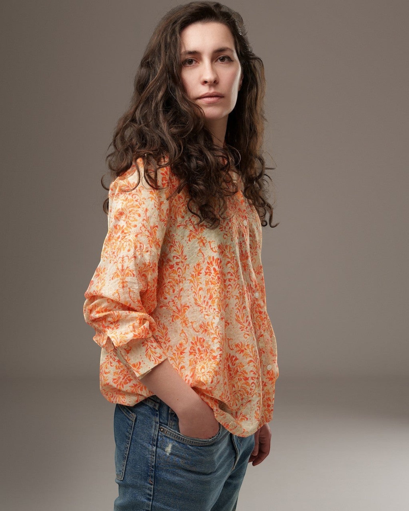 All Above Boutique loose-fit rayon shirt with orange and pink floral print, featuring a relaxed fit, dropped shoulders, and buttoned cuffs.