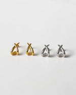 All Above Boutique gold and silver organic asymmetric stud earrings with a polished finish.
