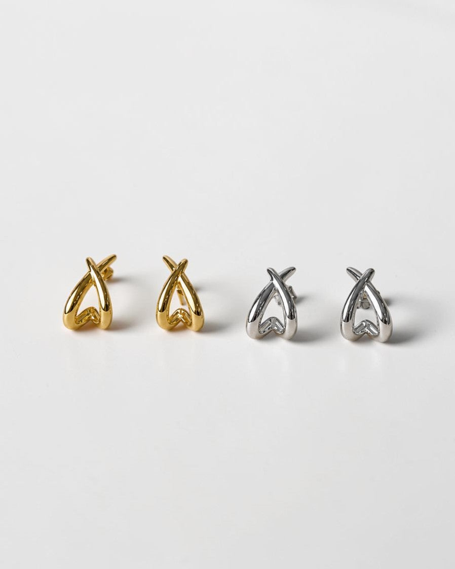 All Above Boutique gold and silver organic asymmetric stud earrings with a polished finish.
