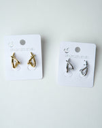 All Above Boutique gold and silver organic asymmetrical stainless steel earrings with a glossy finish.