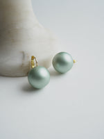 All Above Boutique large pale green pearl drop earrings with gold-tone stainless steel leverback closures.