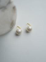 All Above Boutique statement pearl earrings with stainless steel closure. Creamy white, lustrous synthetic pearls.