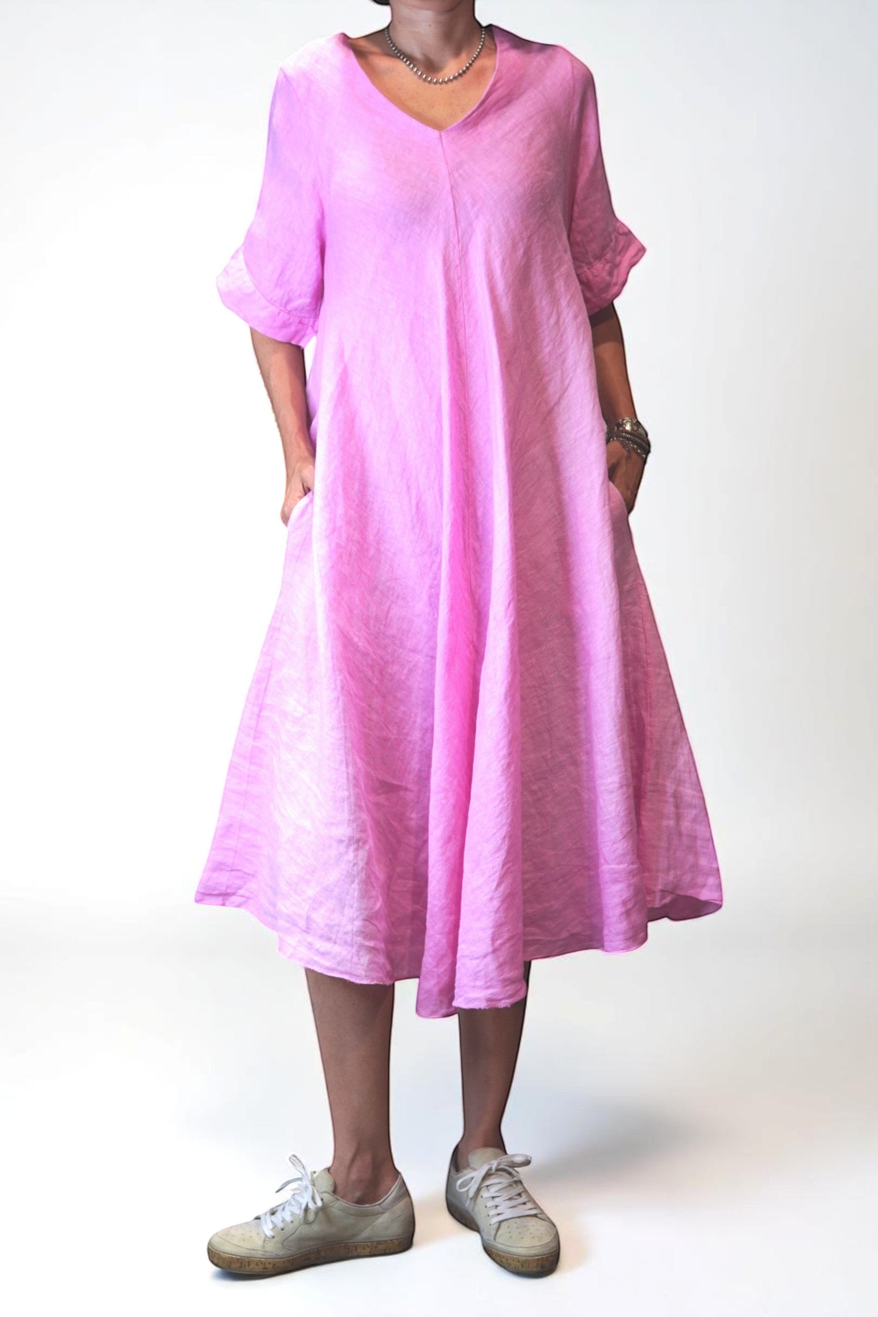 All Above Boutique pink 100% linen V-neck midi dress with side pockets and short sleeves.
