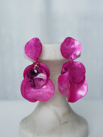 All Above Boutique statement earrings with layered pink petals and iridescent marbled effect, featuring glitter accents.