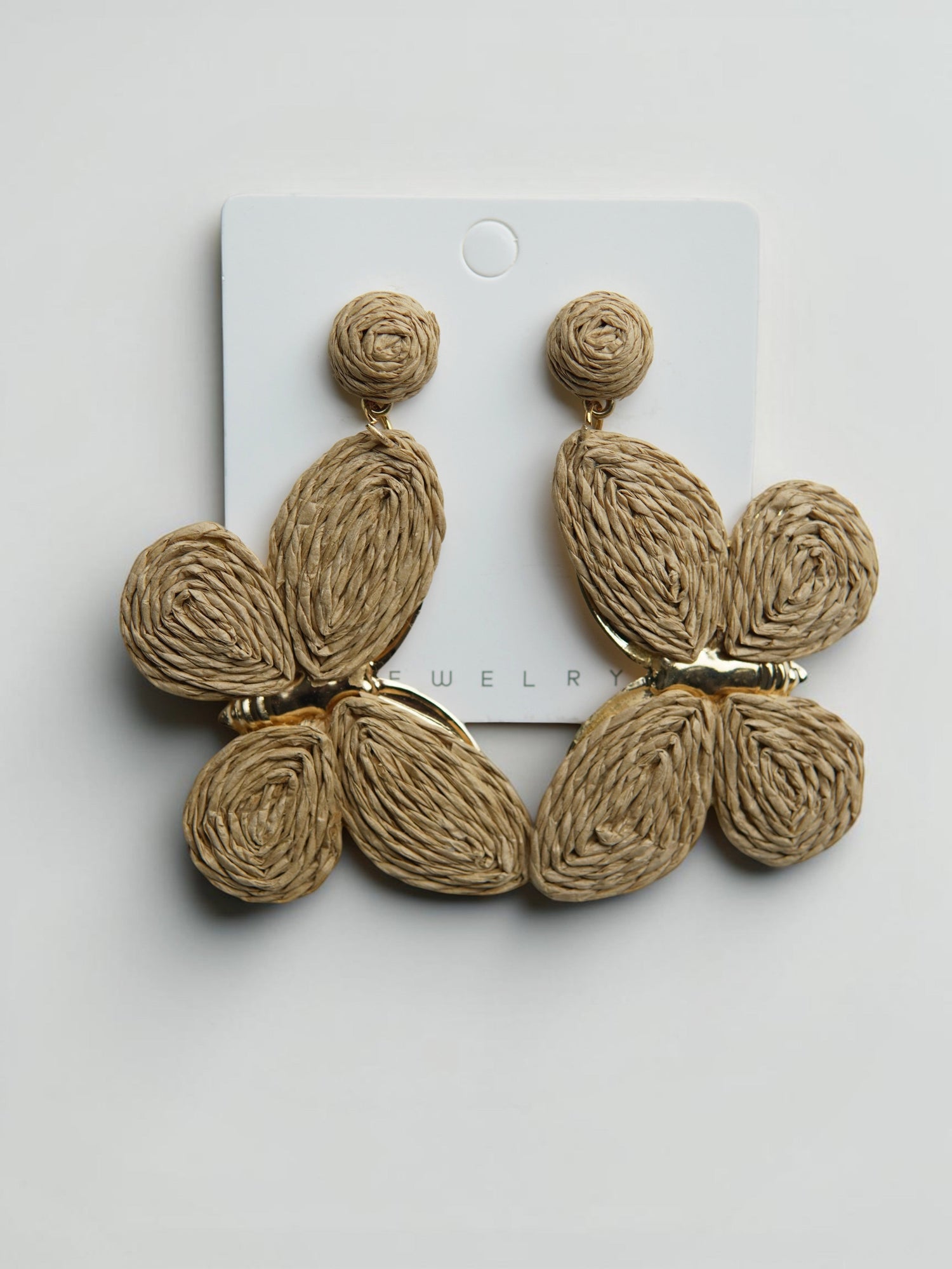 All Above Boutique statement boho butterfly earrings made of natural raffia with gold-tone metal accents.