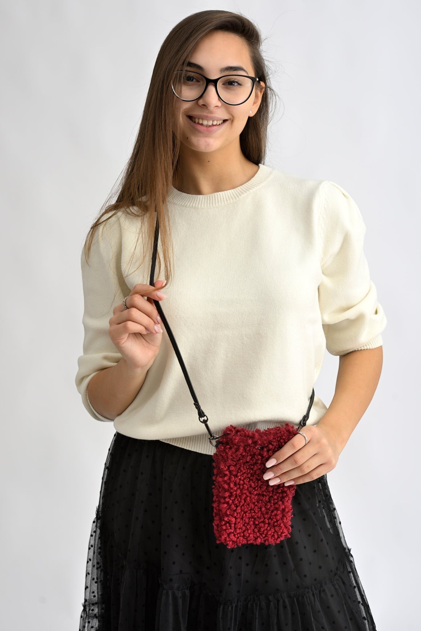 All Above Boutique red bouclé phone bag with adjustable strap, worn crossbody by a model.