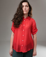 All Above Boutique red rayon shirt with rolled sleeves, front buttons, and a relaxed fit, worn by a woman.