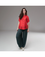 All Above Boutique red rayon relaxed fit shirt with cuffed short sleeves and front buttons, paired with dark teal wide-leg pants.