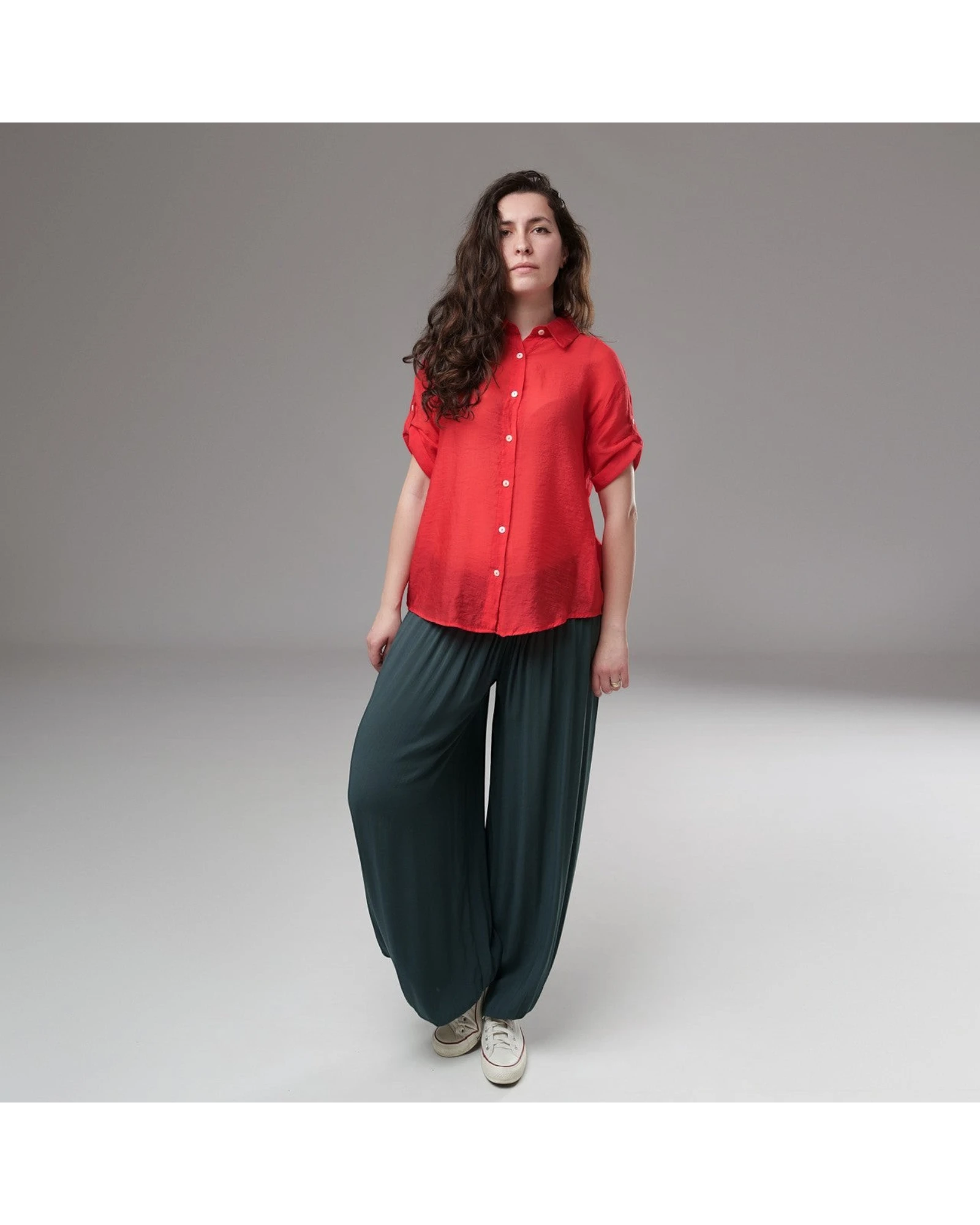 All Above Boutique red rayon relaxed fit shirt with cuffed short sleeves and front buttons, paired with dark teal wide-leg pants.