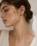 All Above Boutique silver knot floral stud earrings with a polished metallic finish, perfect for elegant everyday wear.