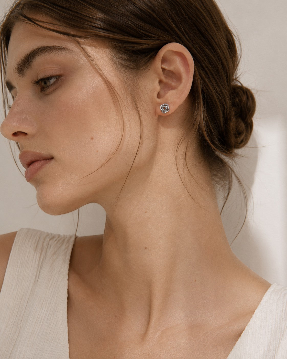 All Above Boutique silver knot floral stud earrings with a polished metallic finish, perfect for elegant everyday wear.