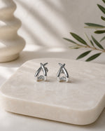 All Above Boutique silver organic asymmetrical stud earrings with a polished finish.