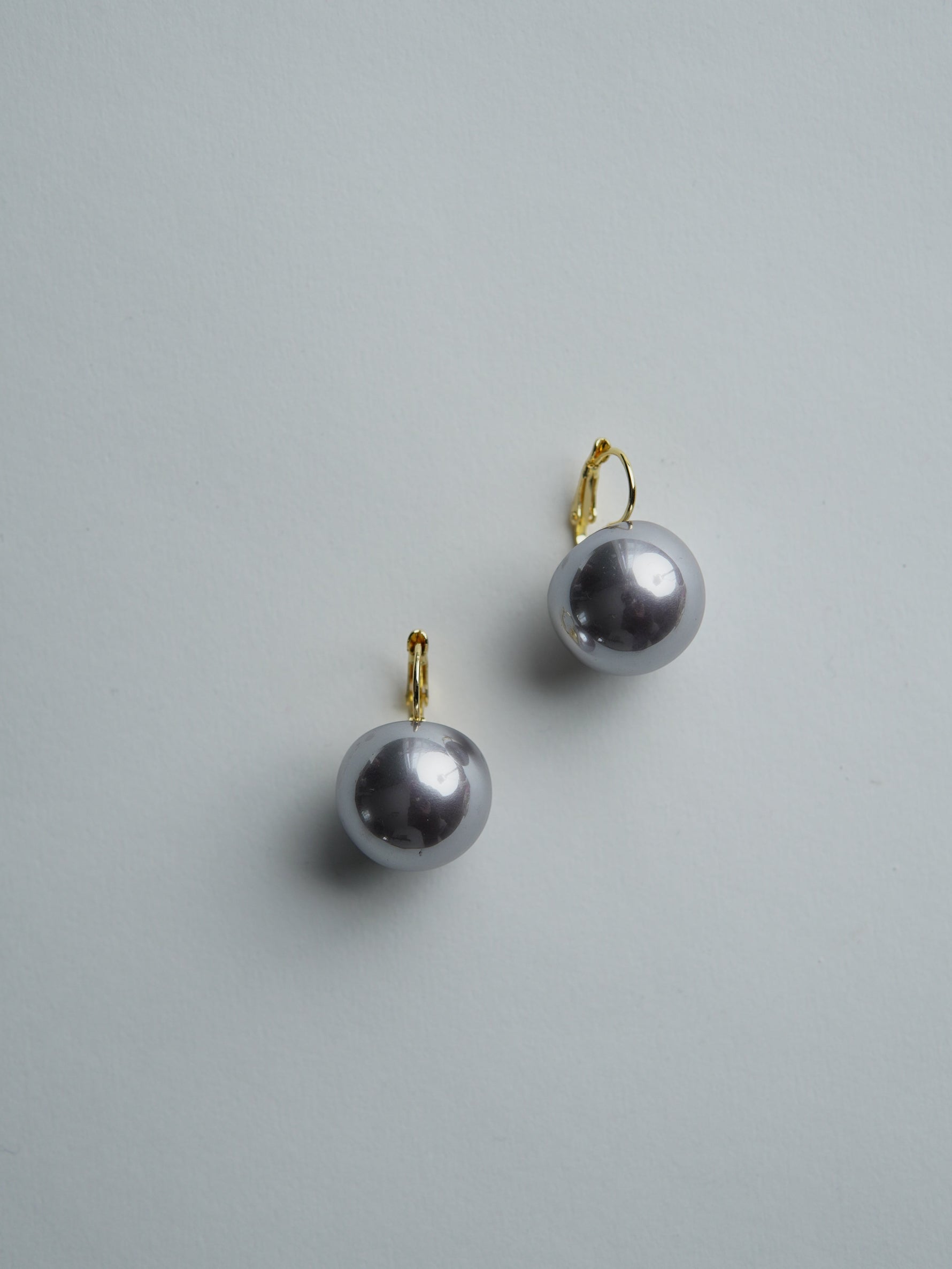 All Above Boutique silver pearl drop earrings with stainless steel clasps. Classic statement jewelry.