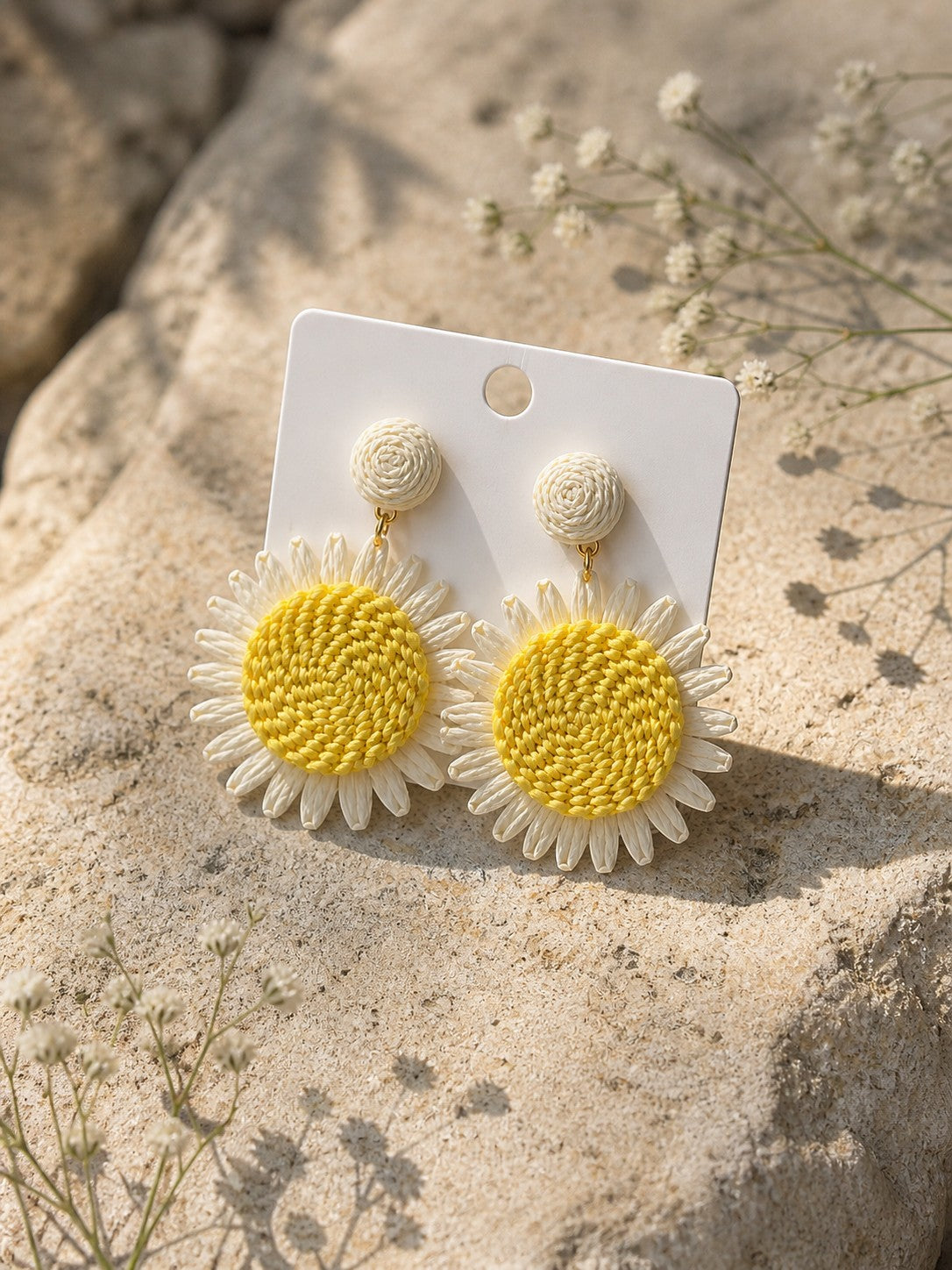 All Above Boutique daisy flower straw earrings with yellow centers and white petals, perfect for summer.