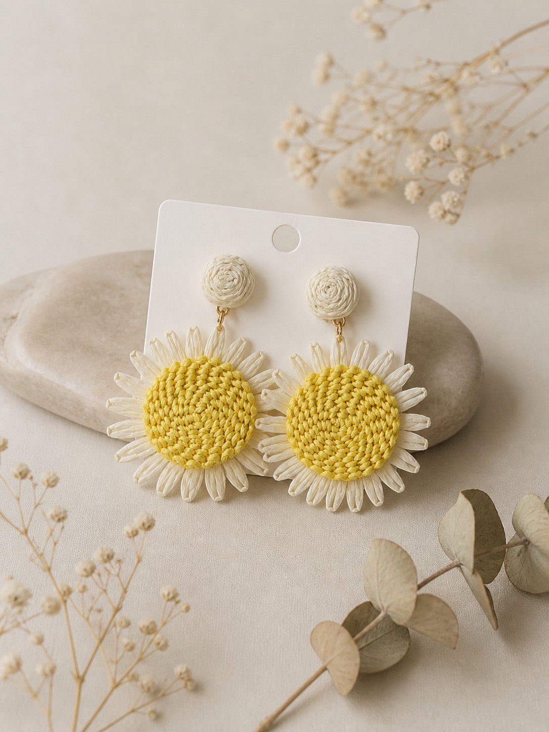 All Above Boutique daisy flower straw earrings with yellow centers and white petals, perfect for summer.