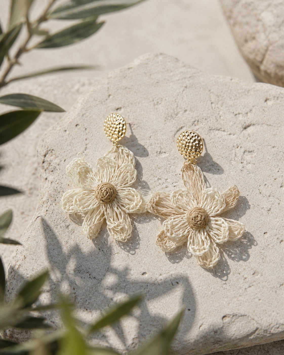 All Above Boutique natural straw flower dangle earrings with gold textured studs.